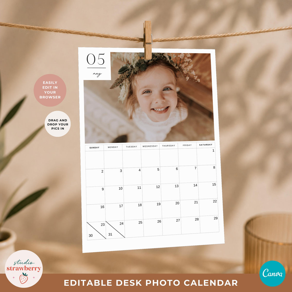 Printable desk photo calendar page hanging from a small wooden clip with a large family photo area and monthly dates.